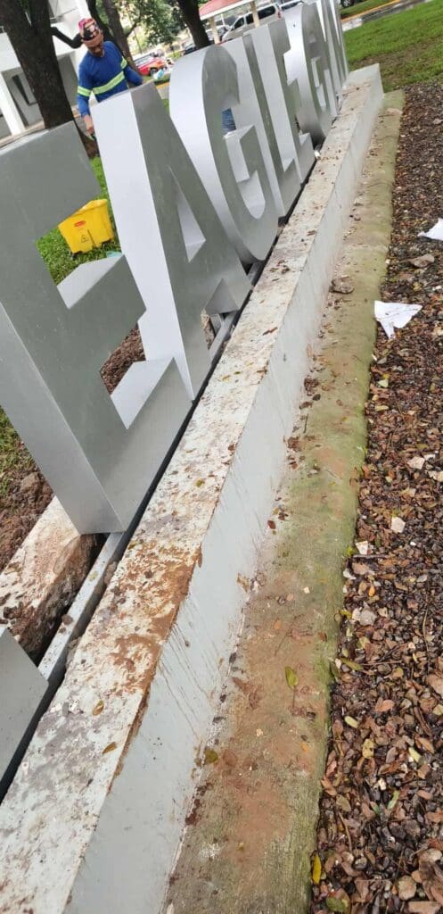 Outdoor concrete base signage with large gray EAGLE letters, installation by sign maker Philippines, Metro Manila by M&G Global Ads.