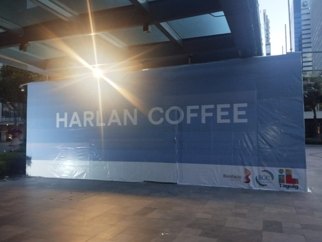 Outdoor construction barrier signage for HARLAN COFFEE in BGC, Taguig by sign maker Philippines. By M&G Global Ads.