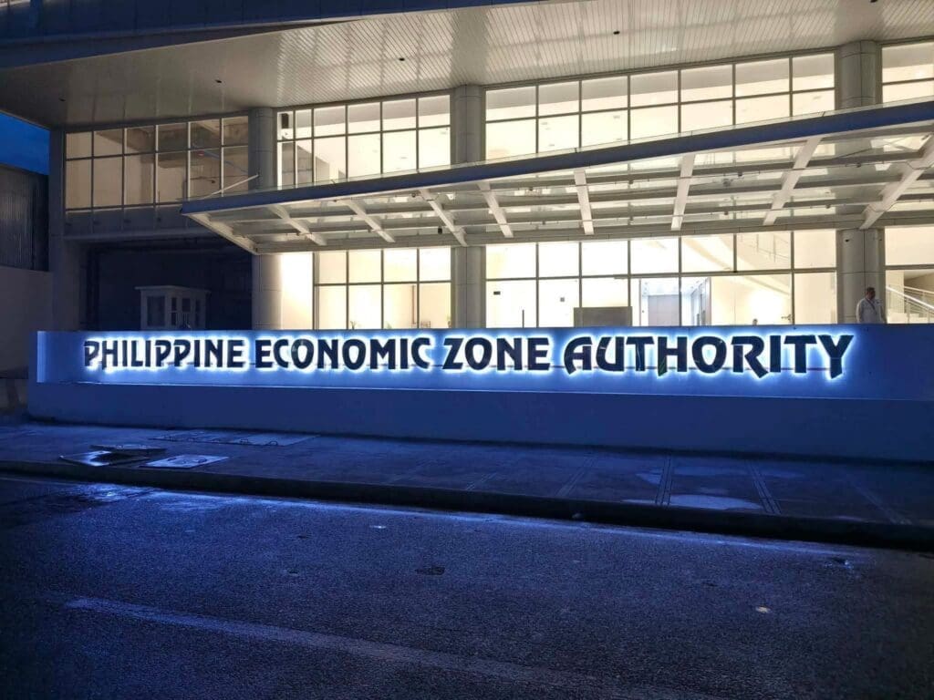 Outdoor LED acrylic signage PHILIPPINE ECONOMIC ZONE AUTHORITY, modern building at night, Metro Manila sign maker Philippines by M&G Global Ads.