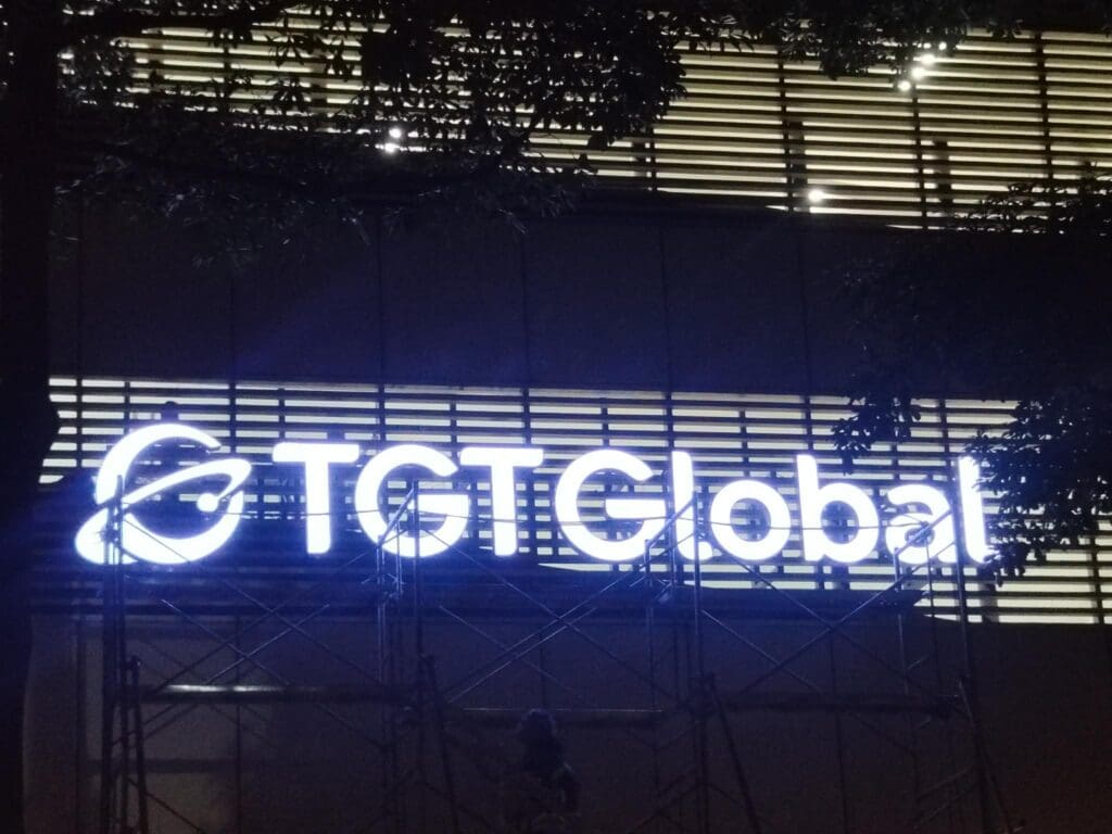Outdoor LED acrylic TGT Global building signage with globe logo, scaffolding, Metro Manila sign maker Philippines by M&G Global Ads.