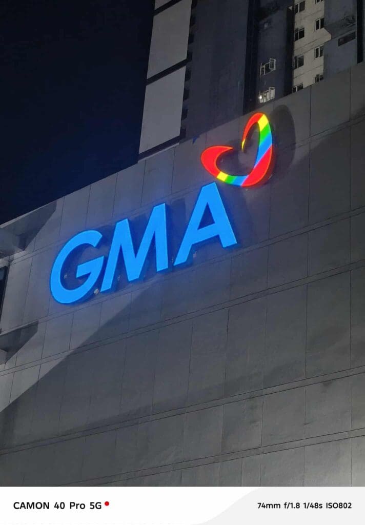 Outdoor LED building signage for GMA with rainbow heart logo in Metro Manila by sign maker Philippines, by M&G Global Ads.
