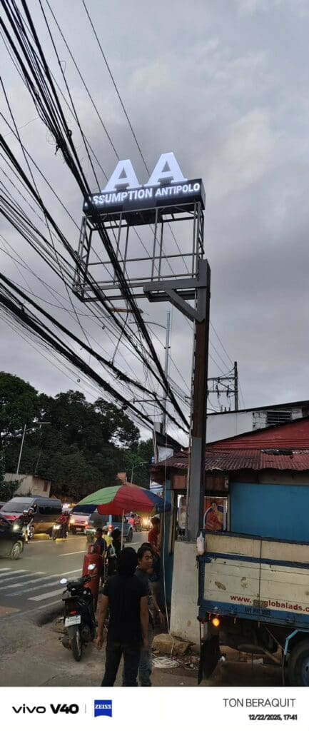 Outdoor pylon sign ASSUMPTION ANTIPOLO on steel frame, roadside, Metro Manila. Sign maker Philippines by M&G Global Ads.