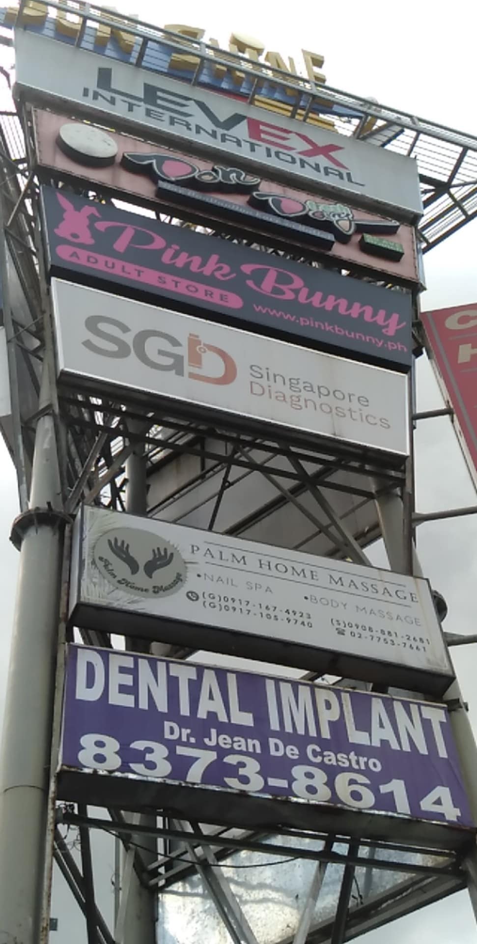Outdoor pylon signpost with acrylic business signs for Pink Bunny Adult Store, Dr. Jean De Castro, Metro Manila by M&G Global Ads, sign maker Philippines.