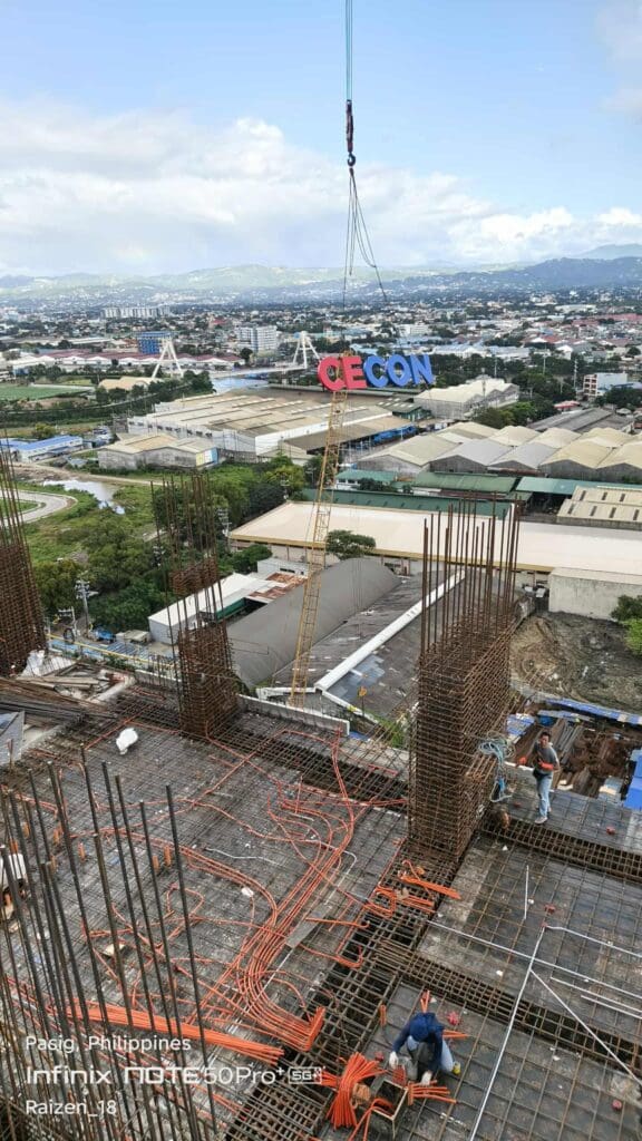 Outdoor tower crane signage installation of large acrylic letters spelling CEGON at construction site, sign maker Philippines by M&G Global Ads.
