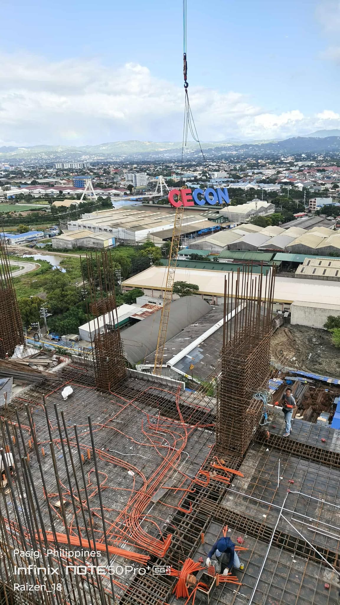 Outdoor tower crane signage installation of large acrylic letters spelling CEGON at construction site, sign maker Philippines by M&G Global Ads.