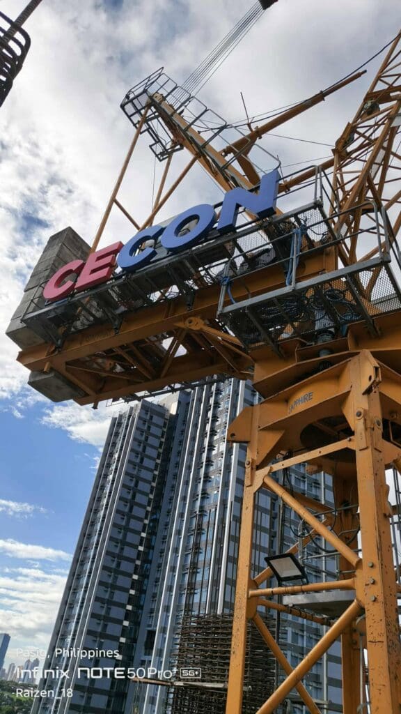 Outdoor tower crane signage with red and blue CECON acrylic letters on crane, Metro Manila, sign maker Philippines by M&G Global Ads.