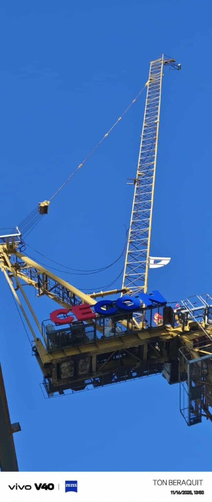 Outdoor tower crane signage with stainless steel details on a yellow crane in Metro Manila by sign maker Philippines, M&G Global Ads.