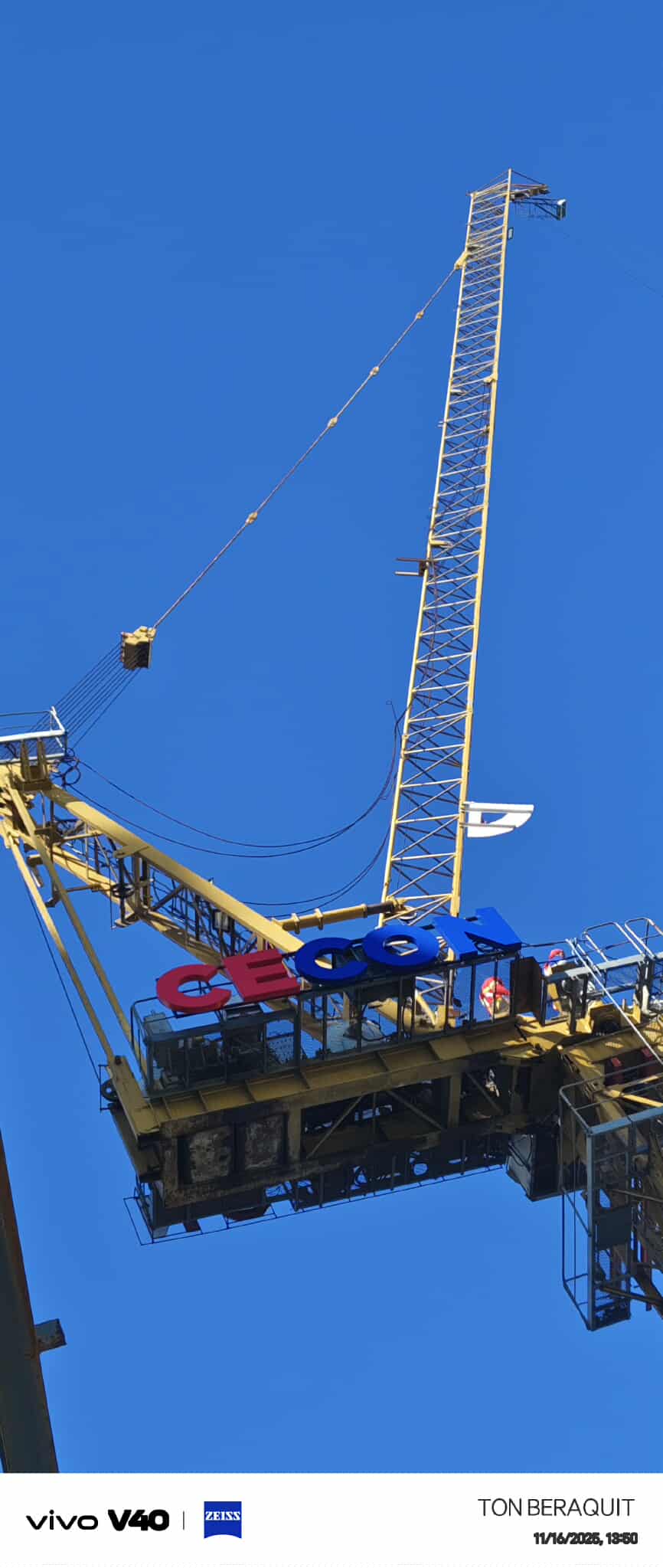 Outdoor tower crane signage with stainless steel details on a yellow crane in Metro Manila by sign maker Philippines, M&G Global Ads.