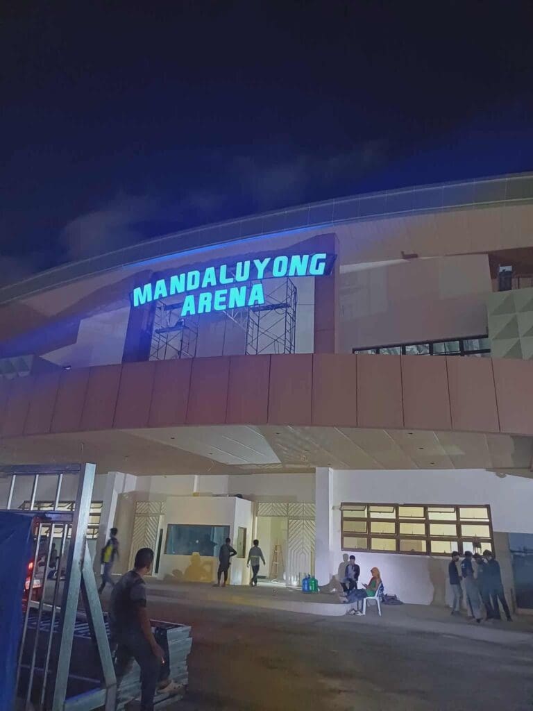 People at Mandaluyong Arena, Metro Manila, with blue LED acrylic building signage by sign maker Philippines, by M&G Global Ads.