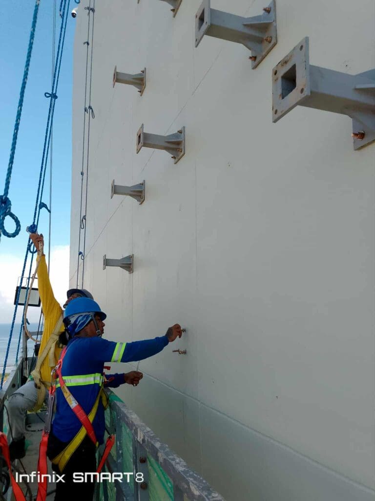 Sign maker Philippines installing outdoor building signage brackets, stainless steel material, Metro Manila by M&G Global Ads.