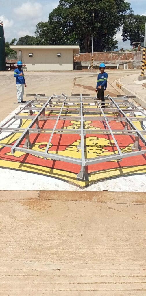 Sign maker Philippines installing outdoor metal frame signage on logo crest, stainless steel material, Metro Manila by M&G Global Ads.