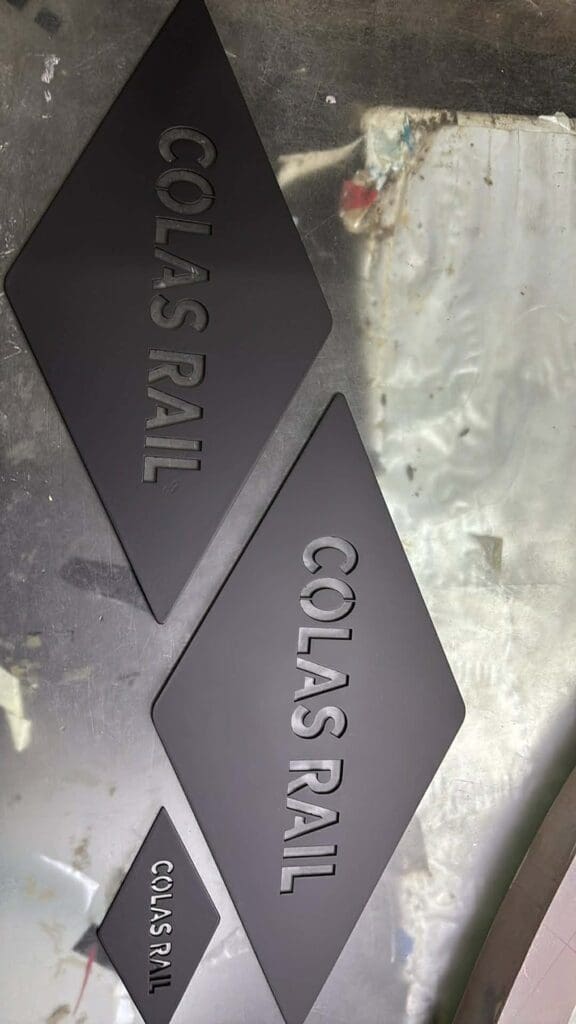 Stainless steel building signage for COLAS RAIL, diamond-shaped plaques, Metro Manila sign maker Philippines by M&G Global Ads.