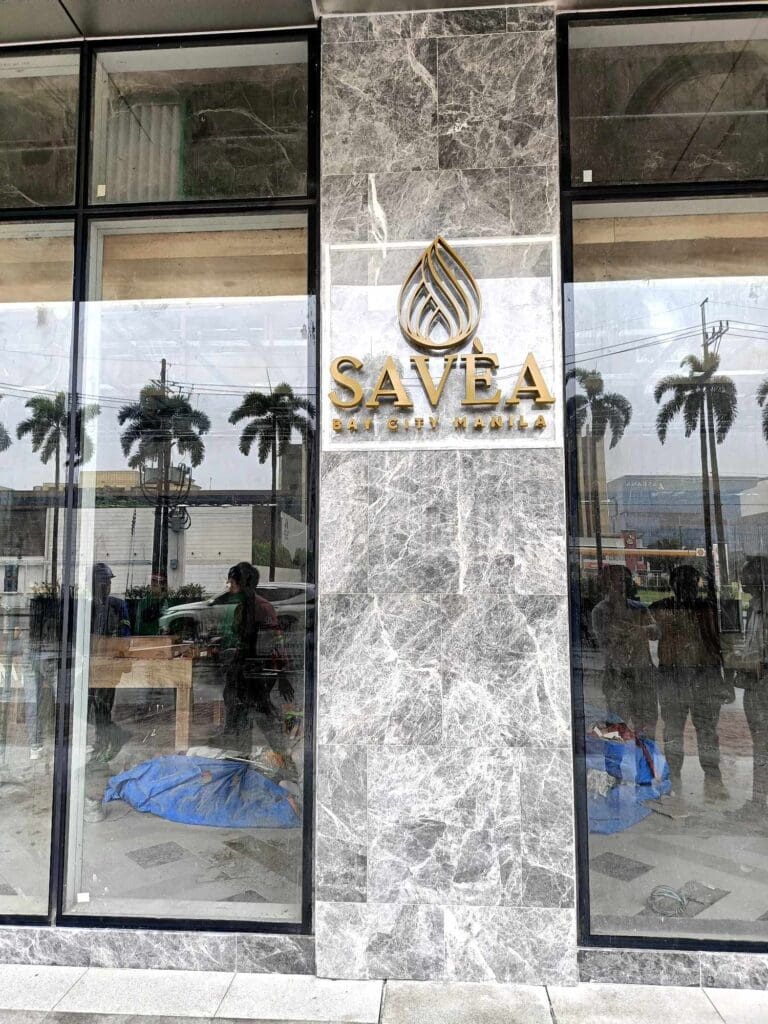 Stainless steel gold building signage for SAVEA, marble facade, Metro Manila sign maker Philippines by M&G Global Ads.