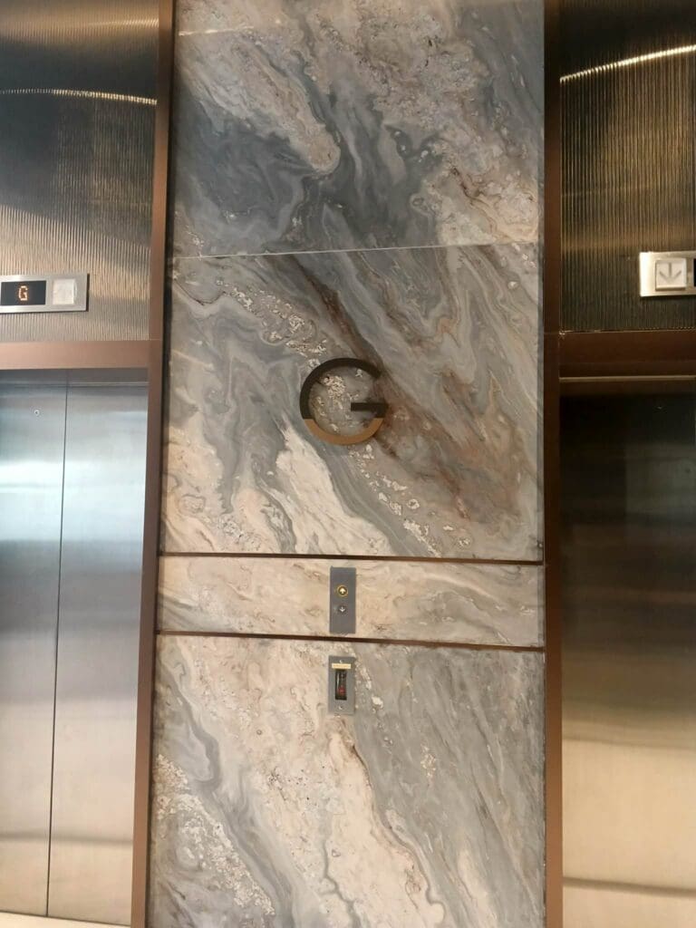 Stainless steel indoor wayfinding building signage with metallic letter G in elevator lobby, Metro Manila sign maker Philippines by M&G Global Ads.