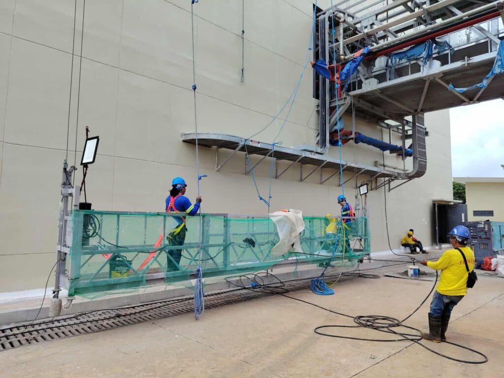 Workers install outdoor building signage, aluminum material, Metro Manila. Sign maker Philippines by M&G Global Ads.